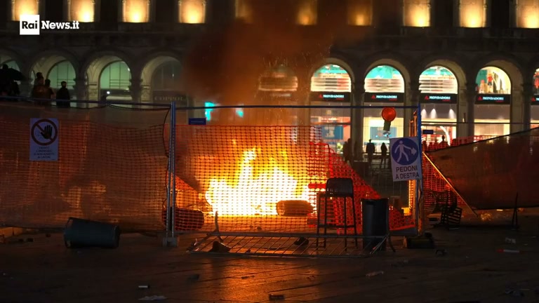 Burning barricade in Piazza Duomo, Milan, at night